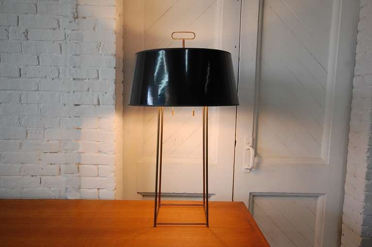 Tommi Parzinger table lamp in brass, with original shade. This is one of the few Parzinger lamps of this particular design, that we've seen, that is actually signed. Brass has a warm, natural patina. We can have the brass high polished, if client so