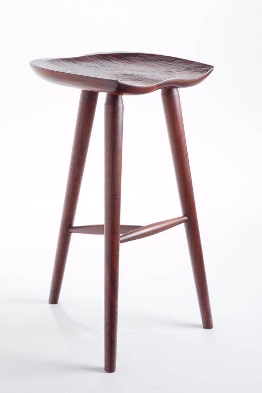 A studio made, hand crafted stool in Walnut. Hand chiseled, saddled seat, with through mortise and tenon joinery as a decorative element. A finely crafted piece of studio furniture
in the manner of George Nakashima / Phillip Lloyd Powell.

We