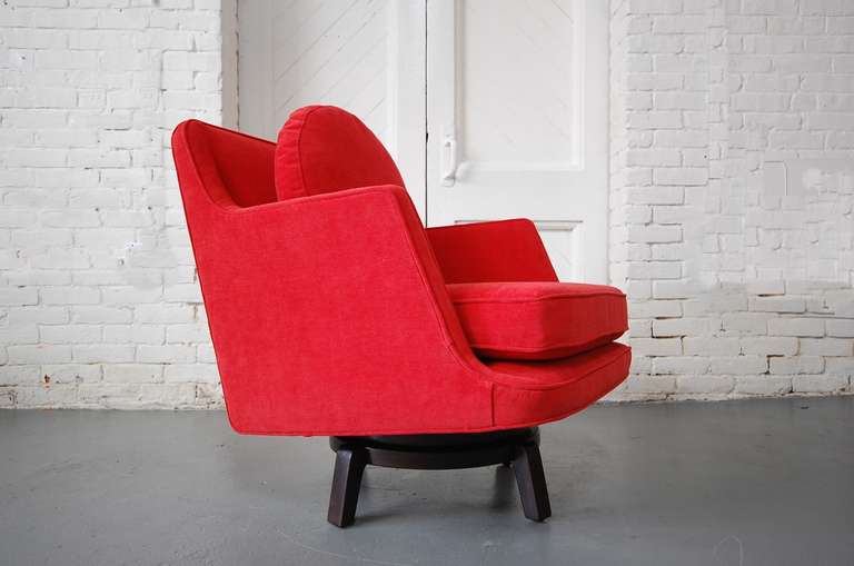 Model #5609 swivel lounge chair designed by Edward Wormley and produced by Dunbar, circa 1965. Newly reupholstered in red chenille. Mahogany base refinished.

If you would like a swatch of the fabric, please just ask. We'd be more than happy to send