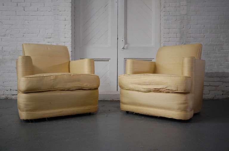Fabulous pair of Lounge Chairs on small castors. Purchased at G. Fox & Co. in Hartford, Connecticut by original owner in 1954. Currently in their original yellow silk. Sold as found. Will need to be reupholstered. We can have these chairs