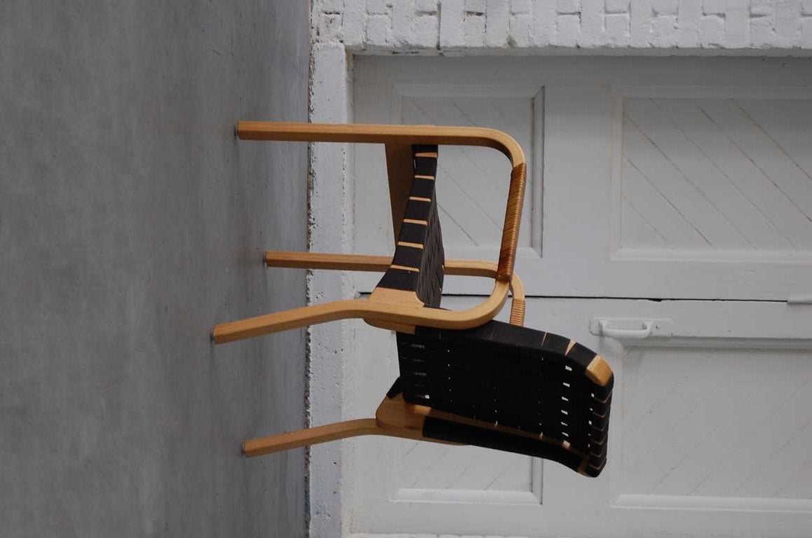 Set of four model 45 armchairs designed by architect Alvar Aalto, and produced by Artek, Finland. Designed 1947. Birch with linen webbing and cane wrapped arms.

We offer free delivery within the Long Island / Greater NYC,
northern New Jersey,