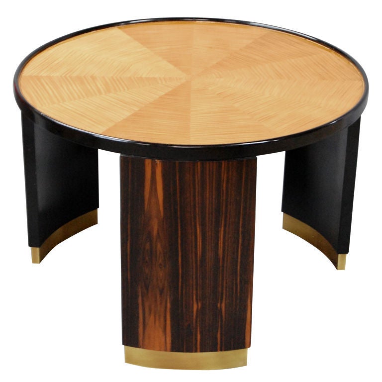 Round occasional table in sunburst tiger maple, black lacquer, madagascar ebony and brass sabots designed by Bernhard Rohne for Mastercraft. A beautifully crafted table with a French Art Deco aesthetic.

We offer free delivery within the Long