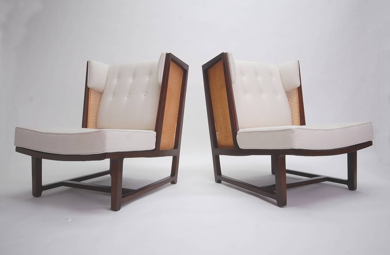 Rare pair of high back wing chairs designed by Edward Wormley, and manufactured by Dunbar, circa 1958. Constructed of mahogany, with cane sides and backs. Upholstered back insert is removable. Completely restored. Professionally refinished,