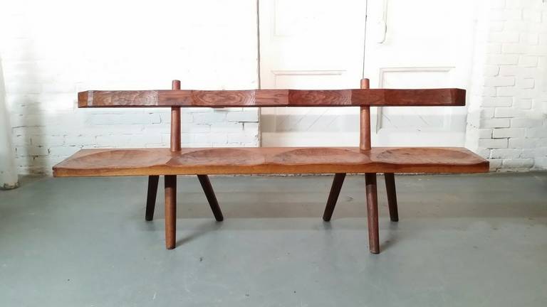 Bench in red oak by Atelier Marolles. Marolles was a group of artisans in France headed by Jean Touret in the 1950s and 1960s. Bench is constructed of red oak, and has hand-wrought iron hardware.

We offer free delivery on most of our items within