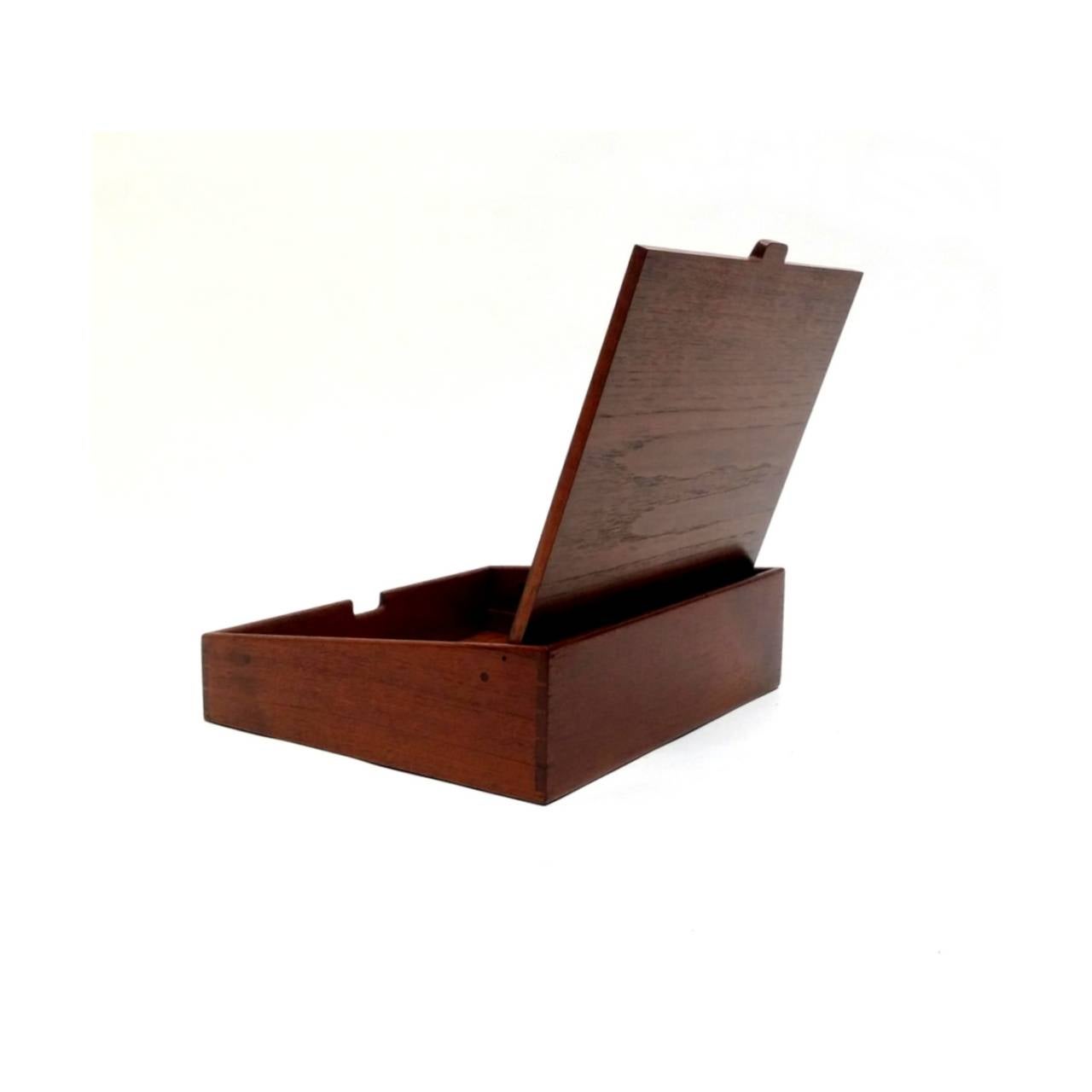 Teak jewelry or desk box designed by Ejnar Larsen and Aksel Bender Madsen, and crafted by cabinet-maker Willy Beck of Copenhagen, Denmark. The boxes lid opens to reveal a mirror, as well as storage. Interior can be changed to a number of different