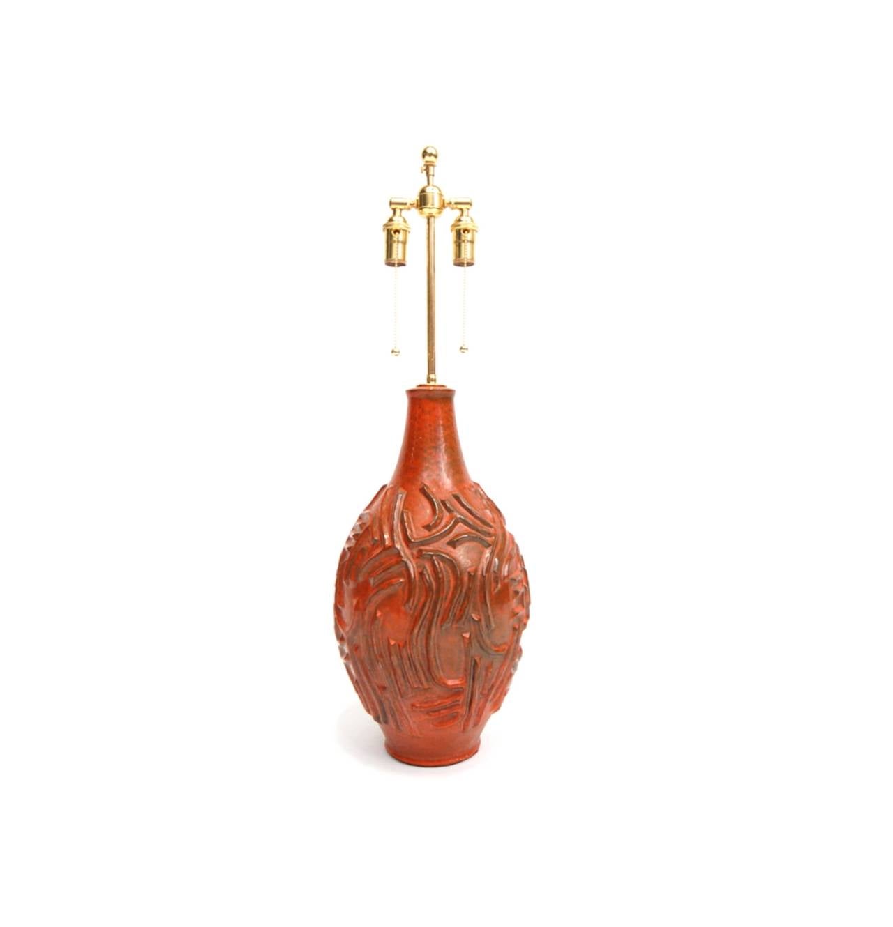 Large pottery lamp in orange/red mottled glaze, circa 1970. Newly rewired (as all of our lighting is) with rayon wrapped braided cord. Measures 32