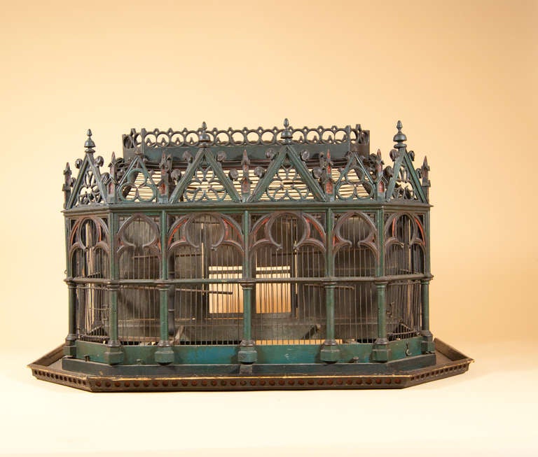 Just about THE most amazing birdcage we have seen in years - and superb quality.The pale green colour is enchanting, as are the red highlights at the gothic arches.

This dates to about 1870 or so, and is probably French (but could also be
