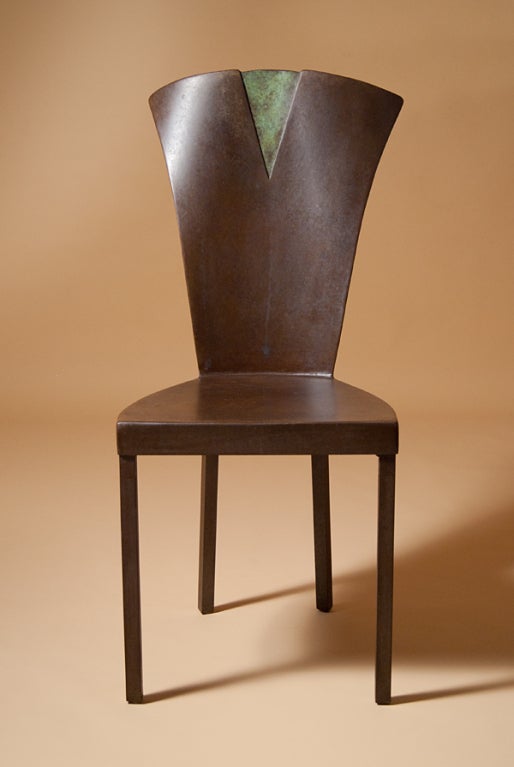 A steel side chair with a scrolled crest rail, appearing, almost, as if it is two pieces being ripped apart to reveal the inner green.

Ask us about our reduced-rate shipping plans.  
Sometimes we are even able to offer Free Shipping, depending