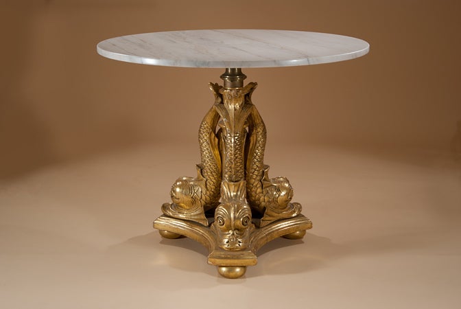 An early 19th century carved and gilt centre table. The dolphin motif reflects the interest of a great seafaring nation and was a popular motif at this time.  The table retains most of its original gilding. 
The marble top is a later