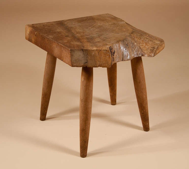 A low table or stool by James Martin:

Walnut with a free edge on two sides and supported on four round bowed legs. Signed underneath.

Contact us for our Reduced Rate Shipping plans (and sometimes its even Free Shipping!).