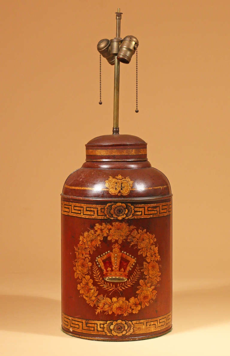 A good 19th century red japanned tole tea canister:

The domed top centering the number 