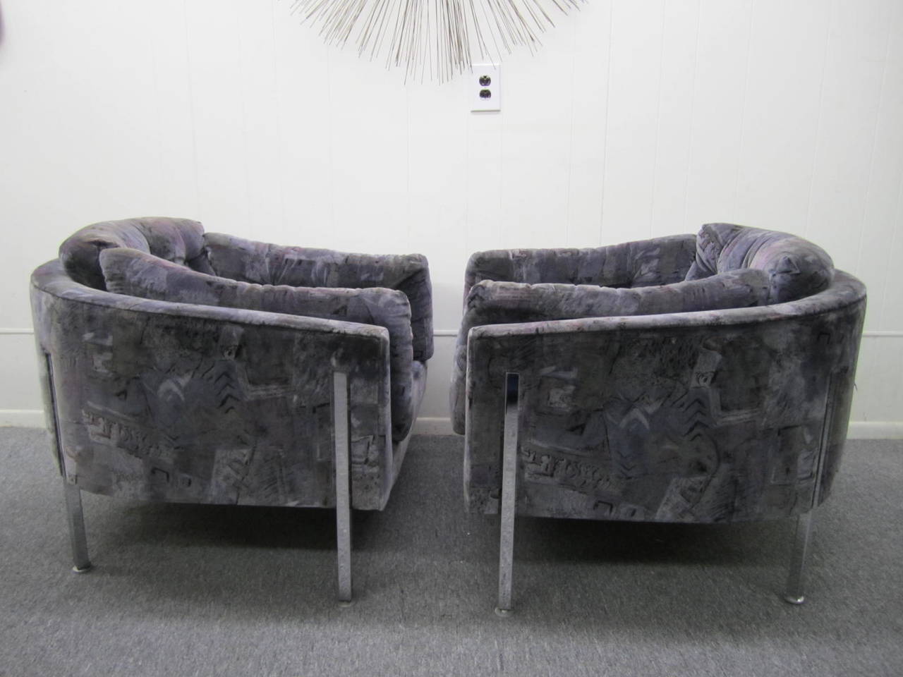 Exceedingly rare pair of oversized Milo Baughman chrome lounge chairs.  These fine chairs were reupholstered in the 80's with a lovely greyish purple patterned velvet in great vintage condition.  We love how the chrome legs are actually recessed