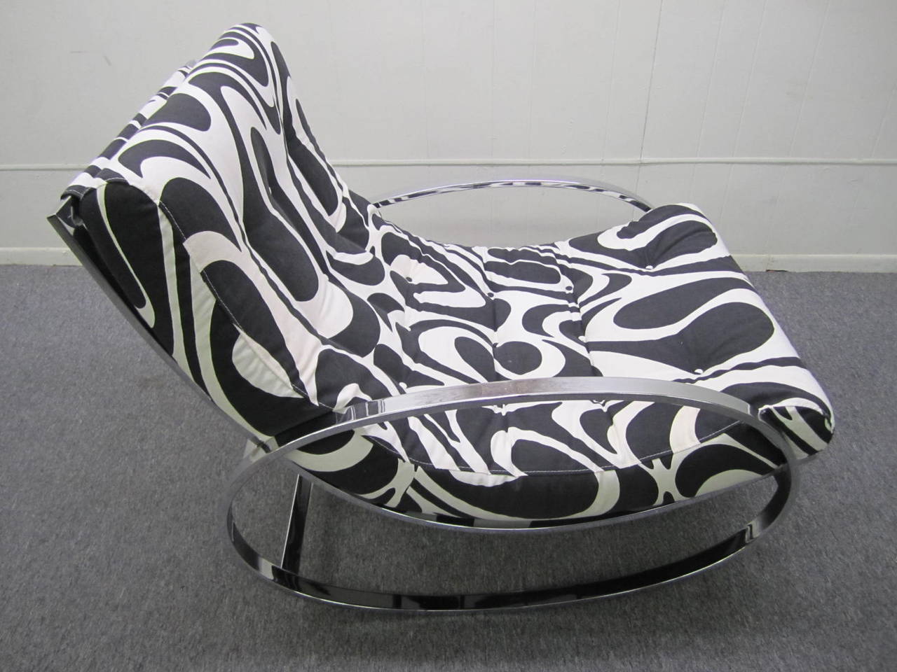 Exciting Milo Baughman style chrome oval rocker. Psychedelic Panton inspired black and white vintage fabric covers the removable pad and looks amazing. The mirror polished chromed frame is also in fabulous vintage condition-a real show piece. Please