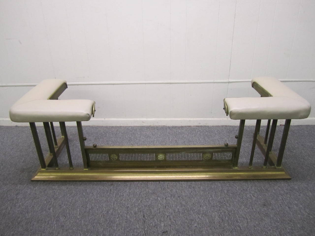 Large Classical club or bench fender or fireplace bench. Cast and stamped brass with upholstered leather top.