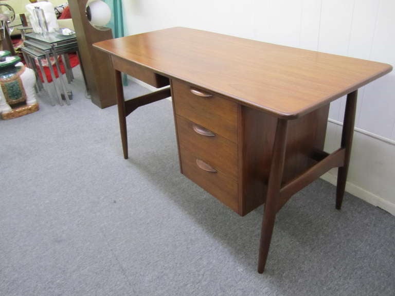 Gorgeous Kai Kristiansen style walnut danish modern desk.  This desk is in great restored condition and shows only mild wear.  Just look how gorgeous the top is and the lovely eyelid pulls.  This piece can be used in the center in the room looking