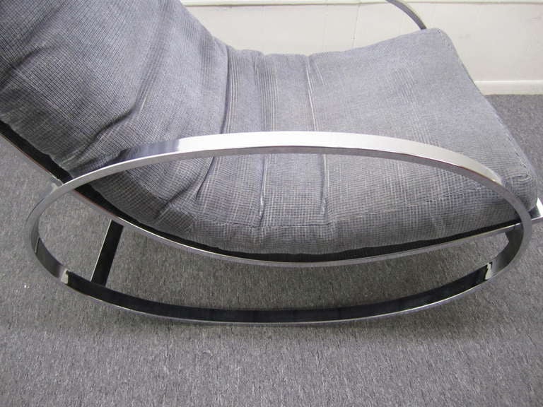 Fabulous Milo Baughman style oval chrome rocking chair.  This chair has it original woven grey fabric still in good condition.  The chrome frame has a nice mirrored finish.  Great form and one of the hippest modernist rockers around.