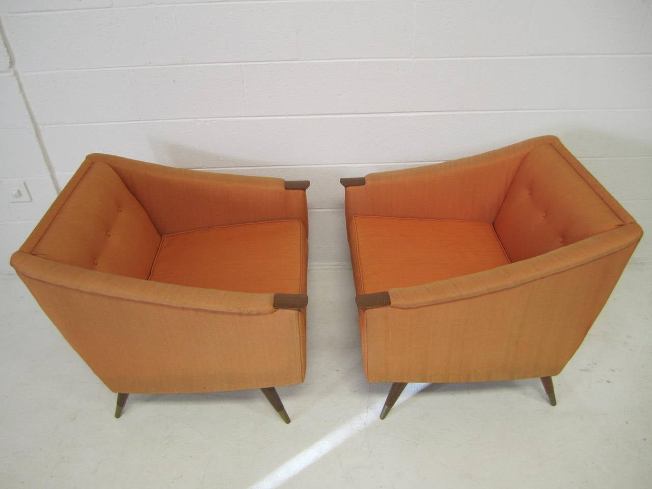 Unusual pair of signed Karpen lounge chairs. Wonderful carved walnut pads give the arms a very stylish and sophisticated feel. The chairs have excellent form and function.