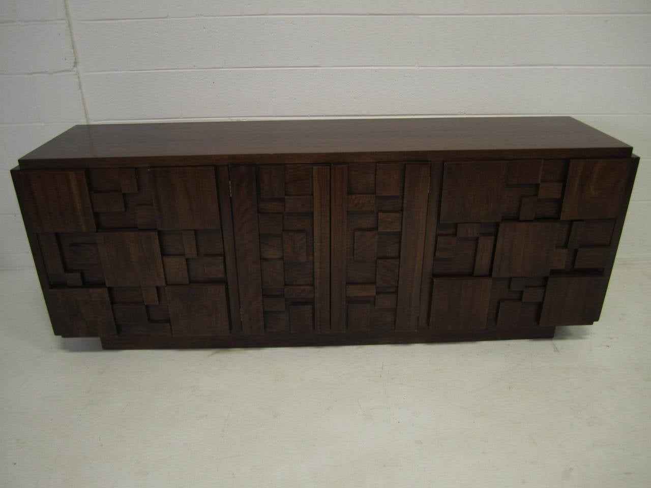 Handsome Paul Evans inspired chunky walnut mosaic credenza made by Lane. This piece is in very nice vintage condition and is very well made. The top has it original finish and looks quite nice. I have several other pieces from the same collection.