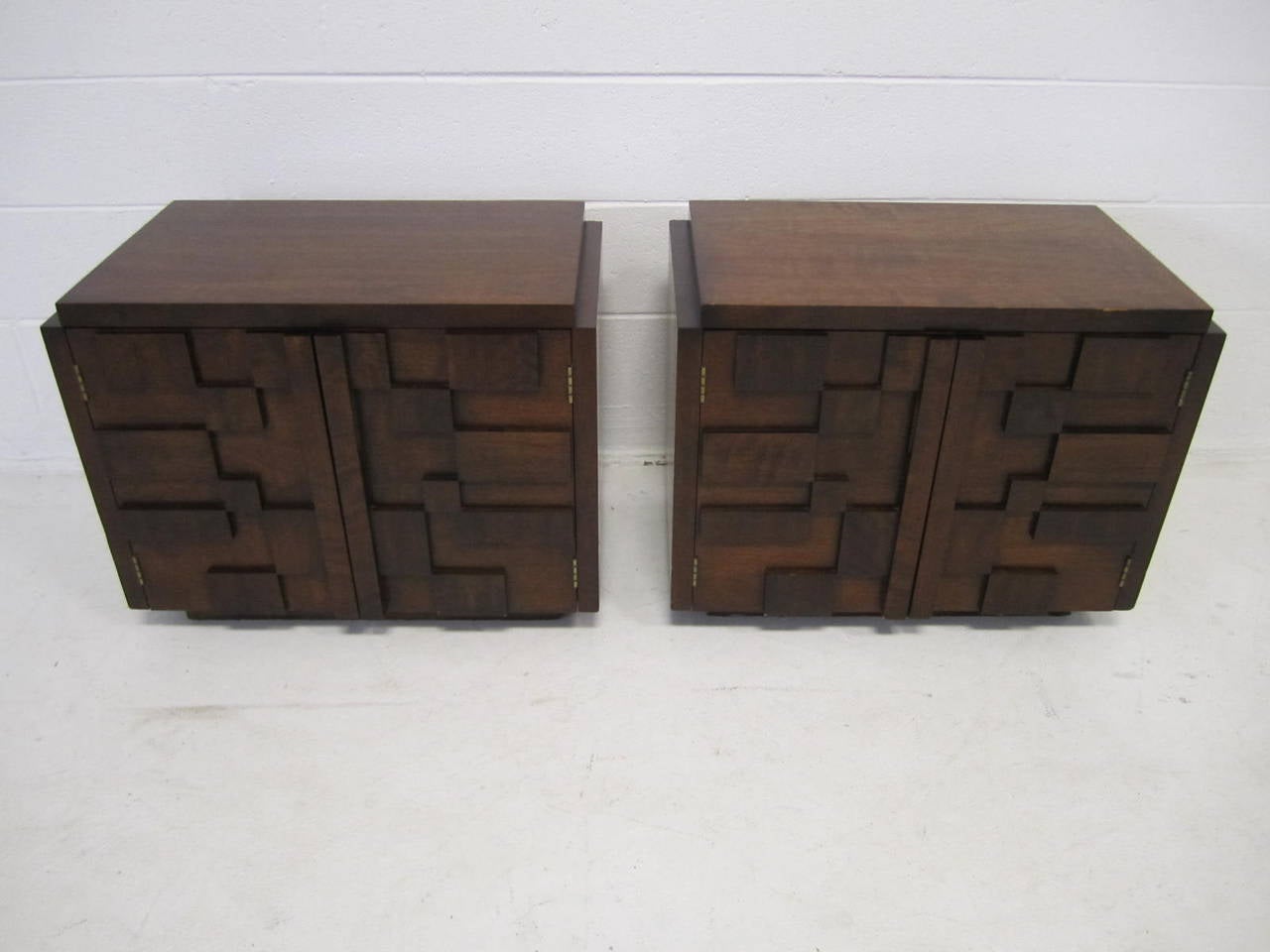 Handsome pair of Paul Evans inspired chunky walnut mosaic nightstands made by Lane. They are well constructed and in very nice condition. The doors open to reveal a nice open space with one fixed shelf. I do have more pieces from this same