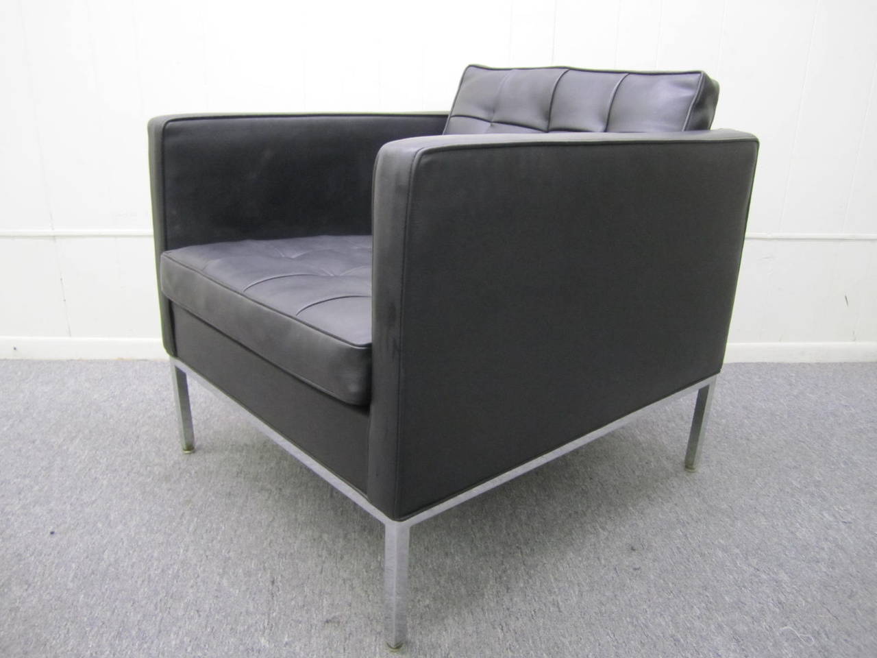 Signed Milo Baughman for Thayer Coggin lounge chair with solid chrome base.  The upholstery is a faux black leather and still looks nice but re-upholstery is  recommended.. The heavy chrome base is very shiny and in great condition.