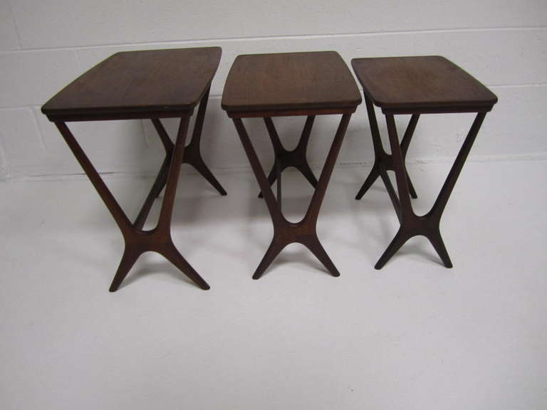 Three danish modern nesting tables attributed to Johannes Andersen.
Richly grained dark teak, beautifully engineered and crafted for maximum style.