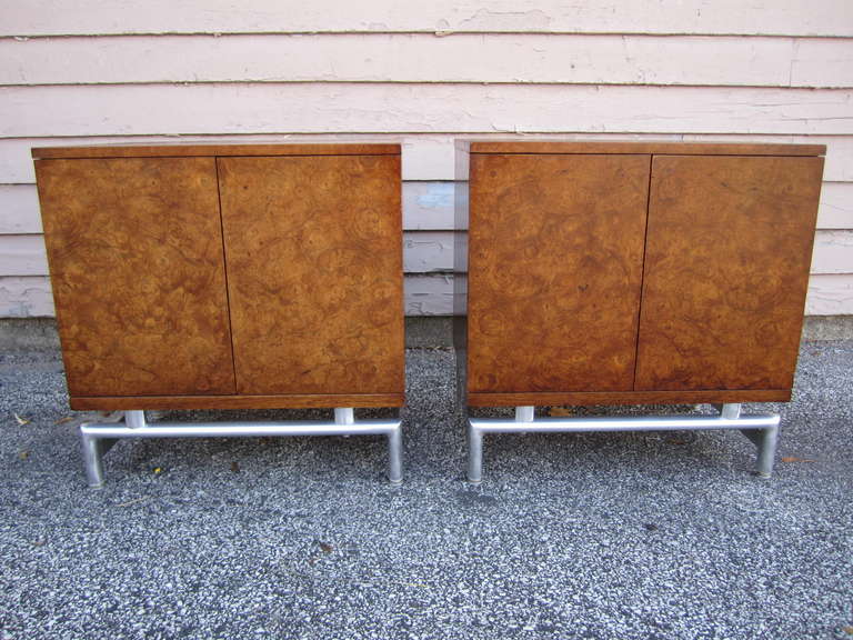 Lovely pair of american modern burled walnut night stands.  I love the contrast of chromed steel bases with the walnut burled doors.  The burled walnut doors open to reveal one drawer and a nice open space each.