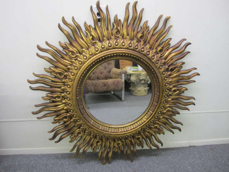 Outstanding and large scale starburst mirror. Gorgeous antiqued golden patina this over the top mirror will be the centerpiece of any decor.