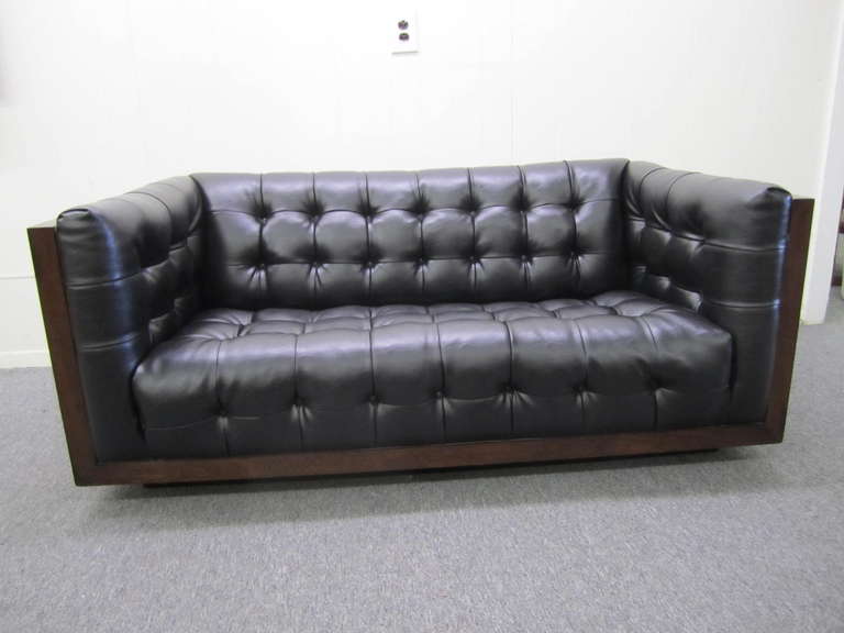 Fabulous Milo Baughman brazilian rosewood case sofa loveseat. This piece is in fantastic vintage condition.  The high grade black faux leather is original and still looks amazing. The brazilian rosewood case is deep, dark and stunning in person. 