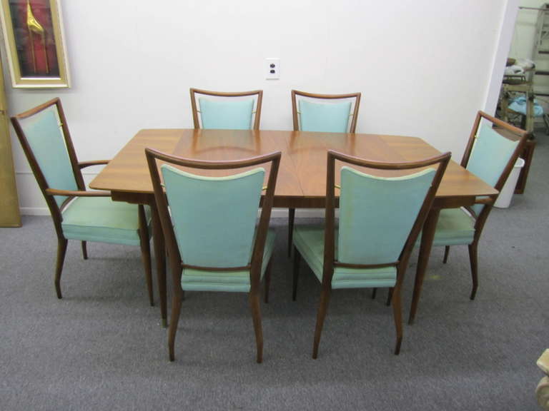 Set of six late 1950's Widdicomb modernist dining chairs in walnut with upholstered seat and floating back cushions held suspended by brass fittings. Designed by J. Stuart Clingman. The sinewy lines, tapered legs and floating back panel are similar