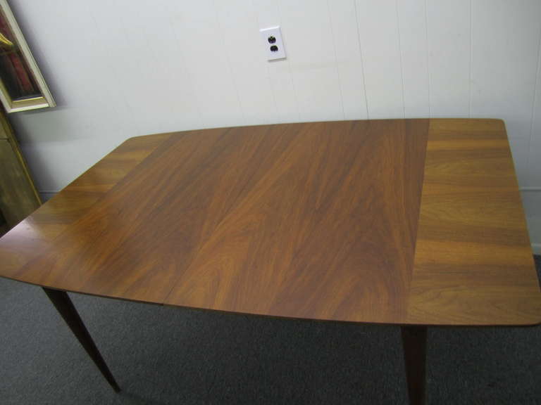 Stunning J. Stuart Clingman for Widdicomb walnut dining table with 3 leaves.  Fabulous thick graining details on each end.  Well constructed and gorgeous in person-you will love the style and condition of this early piece from Clingman.  Please