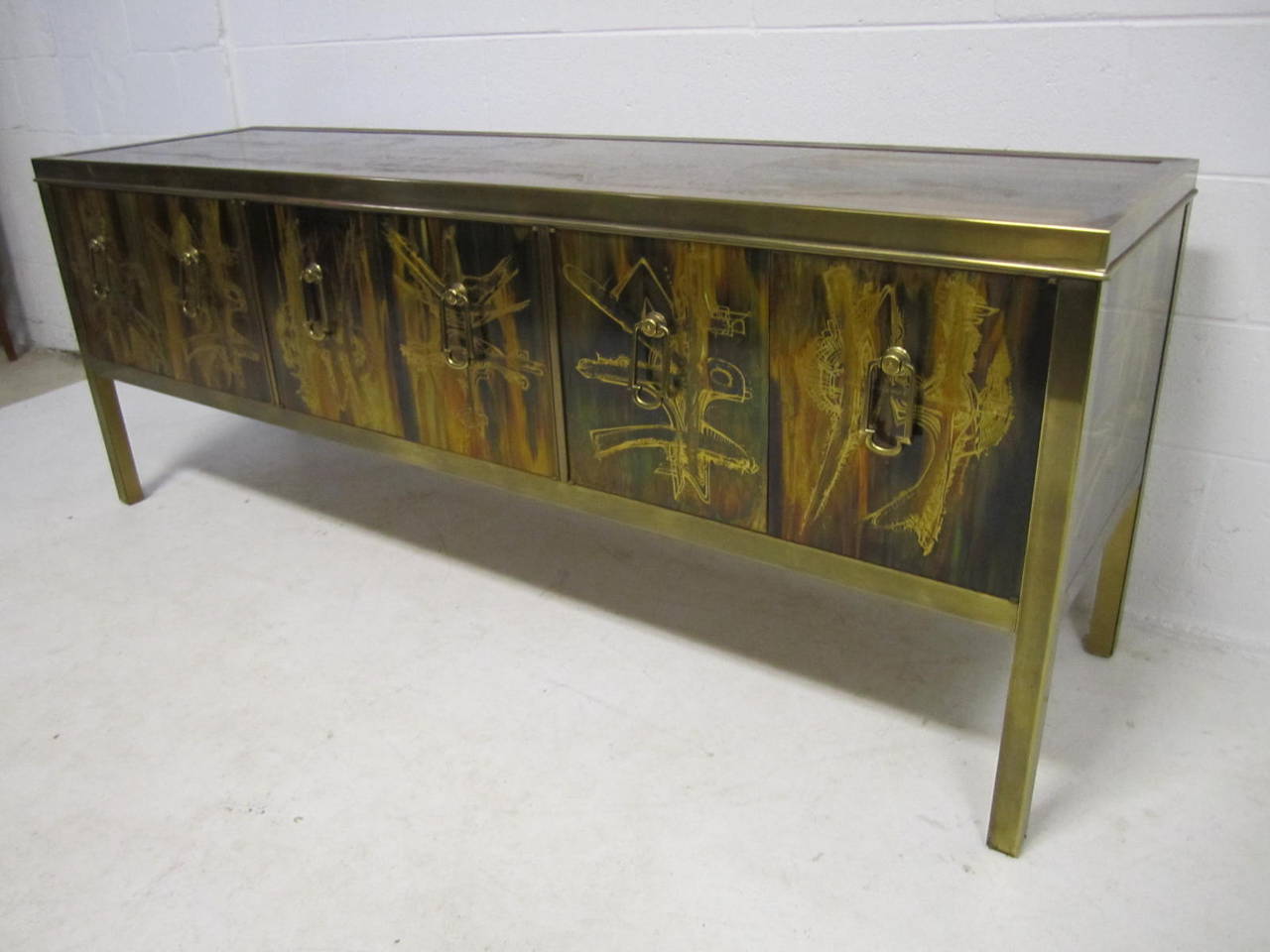 Outstanding Bernhard Rohne for Mastercraft credenza sideboard cabinet. Exceptional six-panel acid etched brass credenza with brass pulls housed in a brass frame. Designed by Bernhard Rohne for Mastercraft. This piece is even more impressive in