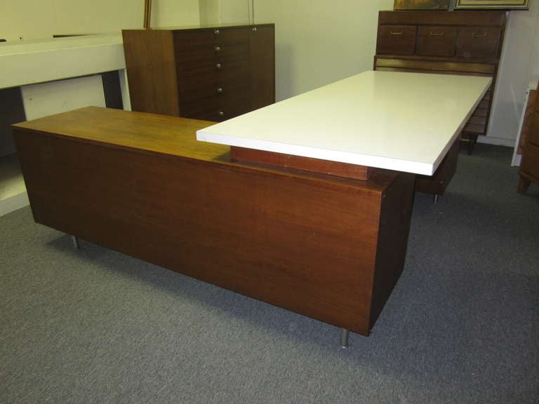 IMPRESSIVE 2 PIECE GEORGE NELSON FOR HERMAN MILLER EXECUTIVE DESK.  THE AMAZING 2 PART DESK HAS TONS OF SPACE WITH 2 FILING DRAWERS,HIDDEN CUBBIES AND A GREAT SURPRISE CABINET IN THE FRONT.  THE ORIGINAL HARDWARE LOOK GREAT MARKED WITH THE HERMAN