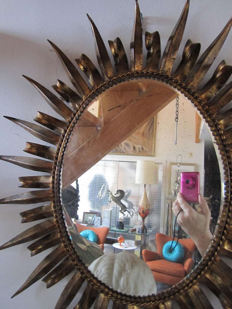 Stunning Hollywood Regency gilded gold Jere style eyelash metal starburst mirror. Well crafted sculpted metal mirror with a wonderful vintage gilded gold finish. Nice size for powder room or foyer.
