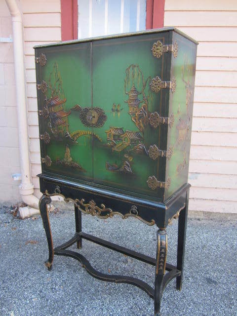 FANTASTIC REGENCY MODERN TALL GREEN CHINOISERIE CABINET IN WONDERFUL VINTAGE CONDITION.  I LOVE THE PATINA THIS PIECE HAS WITH IT WONDERFUL DISTRESSED FINISH.  YOU CAN NOT REPRODUCE A LOOK LIKE THIS, ONLY YEARS OF USE AND LOVE CAN GIVE THE FINISH
