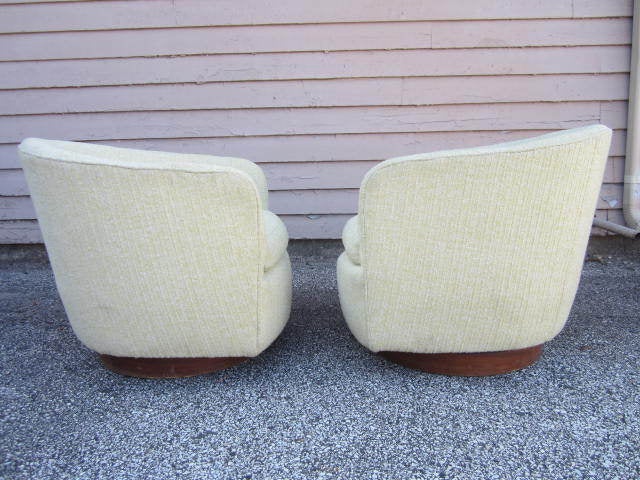GORGEOUS PAIR OF MILO BAUGHMAN SWIVEL ROCKERS IN A LOVELY SHADE OF NUBBY CELERY GREEN WOOL.  THE FABRIC WAS REDONE IN THE LATE 70'S AND STILL LOOKS GREAT.  THIS PAIR LOOK FANTASTIC AS IS-NO NEED FOR ANY RE UPHOLSTERY OR RESTORATION. THE WALNUT