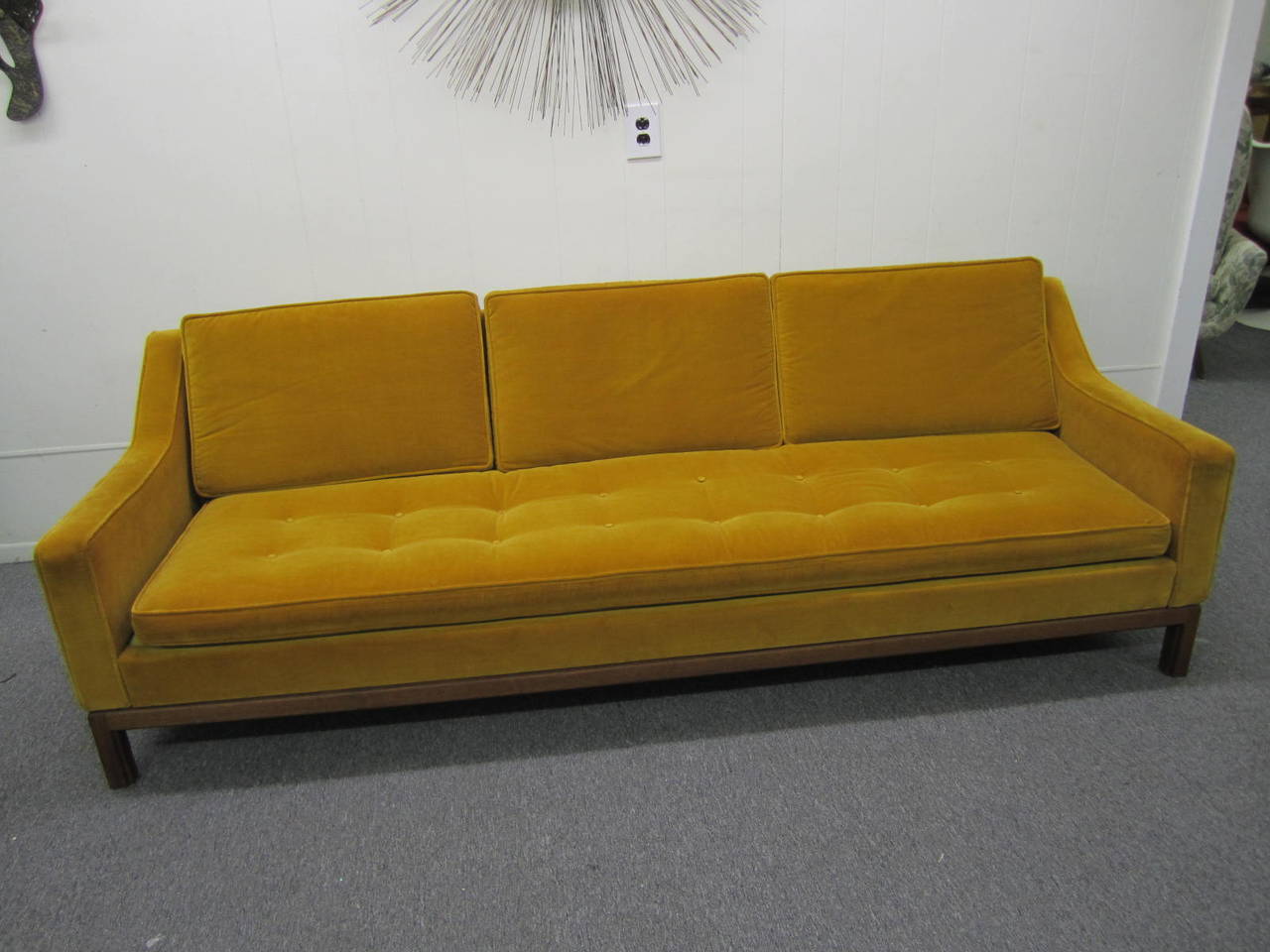 Jens Risom sofa, by Jens Risom Design Inc., USA, walnut frame with carved detail to legs, original orange velvet upholstery with tufted seat cushions and sloped arms, Risom label, 90