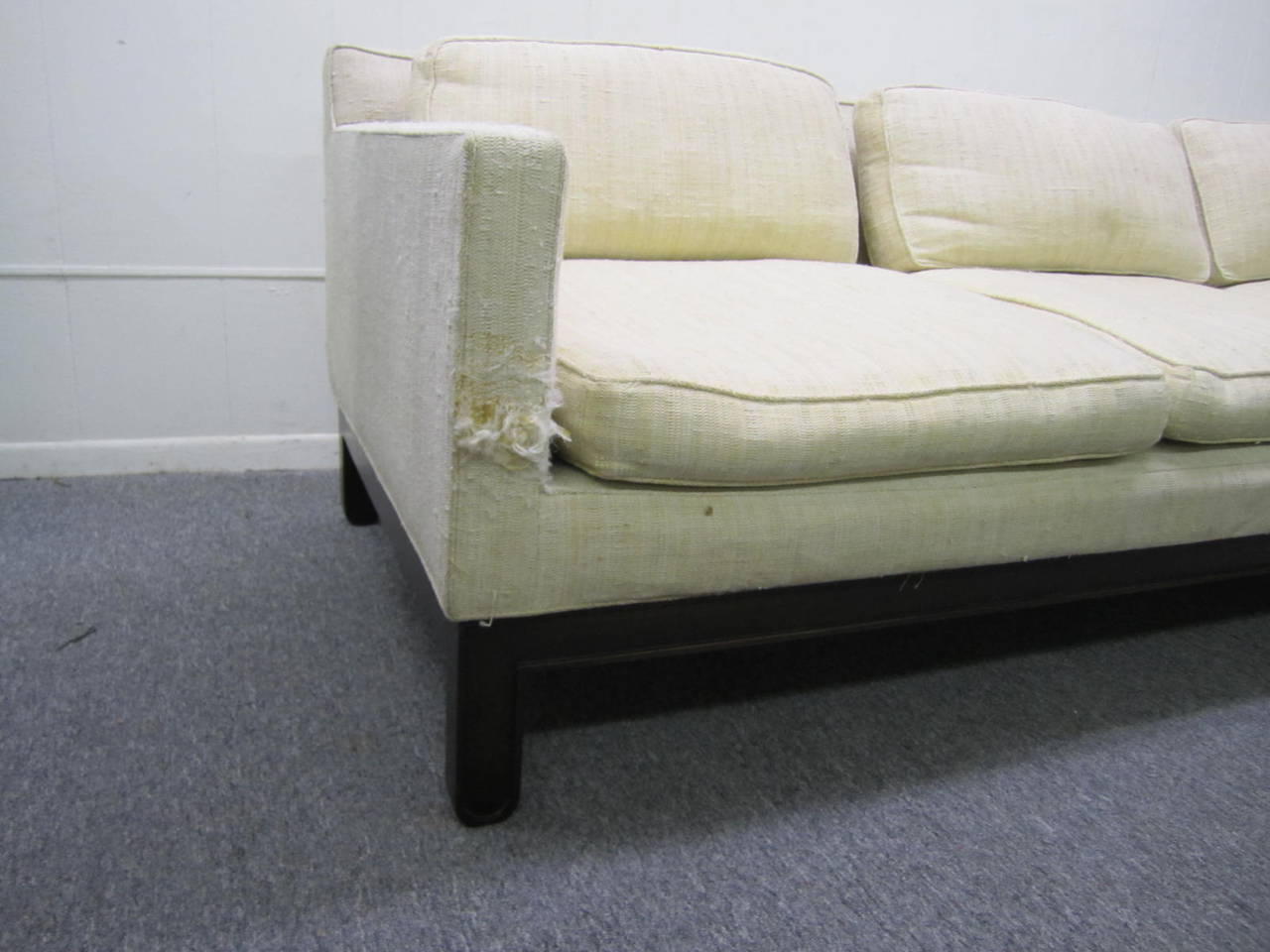 Very stylish Edward Wormley Dunbar sofa with fabulous solid walnut details . This sofa has bold interesting legs that are rounded at the feet. Reupholstery is recommended sofa fabric is in poor condition.  The substantial walnut base is in very nice