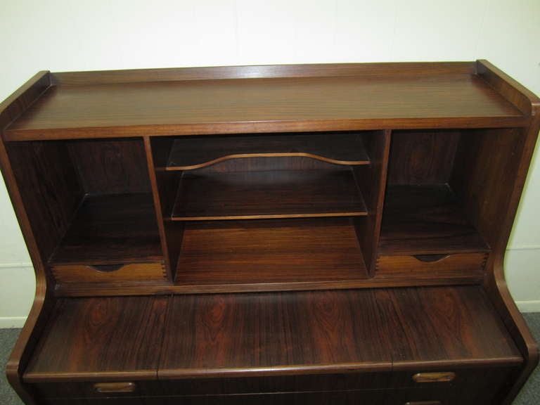 GORGEOUS DANISH MODERN ROSEWOOD PULL OUT DESK WITH FLIP UP COMPARTMENTS.  THE TOP DRAWER SLIPS OUT TO CREATE A NICE DESK TOP AND THEN FLIPS UP TO REVEAL THREE SEPARATE COMPARTMENTS.  THE MIDDLE SECTION HAS A LOVELY HIDDEN MIRROR FOR QUICK FIXES.