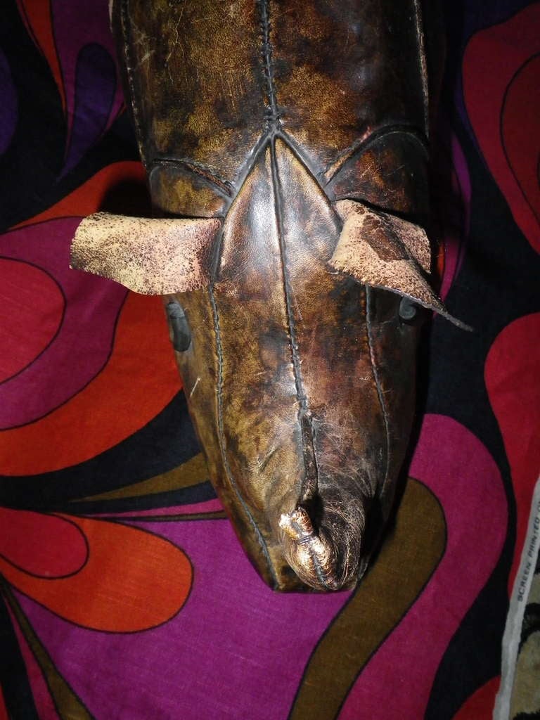 A leather rhinoceros designed by, Dimitri Omersa, manufactured by, Omersa and Company 1Lincolnshire, UK and retailed by Abercrombie & Fitch Company from 1940s -1980s.  This one is in fine condition and has the right amount of vintage patina to the