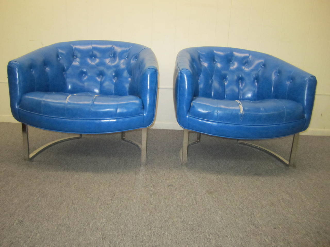 Stunning pair of Milo Baughman style chrome tub chairs. The faux blue leather will need to be replaced but that's what you designers are looking for anyway right? Chrome frames are shiny and look great.