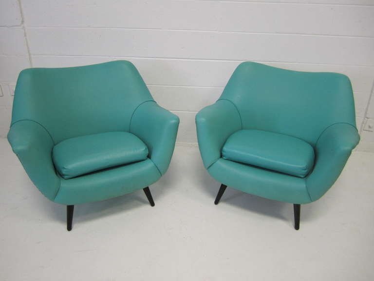 Stunning pair of Lawrence Peabody scoop lounge chairs for Selig.  The pair retain their original turquoise green faux leather upholstery and look terrific.  Super wide seats gives them tremendous style along with outstanding comfort.