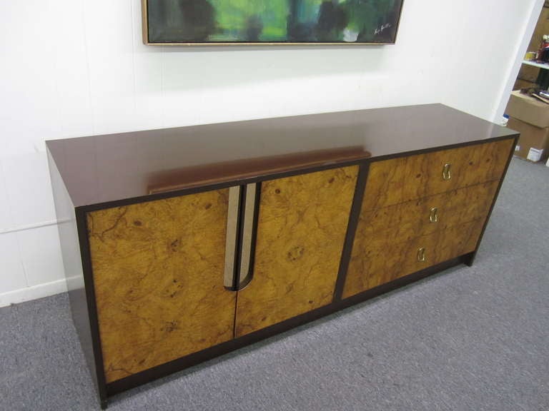 GORGEOUS MILO BAUGHMAN BURLED WOOD AND CHOCOLATE LACQUERED CREDENZA.  THE TOP HAS A SHINEY CHOCOLATE LACQUER IN VERY NICE VINTAGE CONDITION.  THE LOVELY BURLED WOOD DOORS WITH BRASS RECESSED PULLS OPEN TO REVEAL AN OPEN CABINET WITH ONE ADJUSTABLE