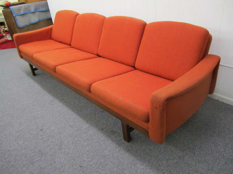 Amazing Danish modern solid teak sofa.  You just have to look at the details to see how wonderful this vintage piece really is.  Notice the sweeping curve of the unusually shaped arms.  I love the arched tops of each of the back cushion along with