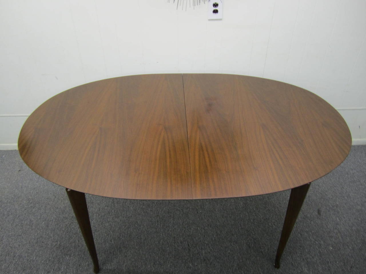 Gorgeous Vladimir Kagan style sculptural walnut dining table with 2 leaves.  Fantastic original condition, the top looks great even with the leaves installed-usually the leaves do not match.  We love the racetrack shape of the top along with the