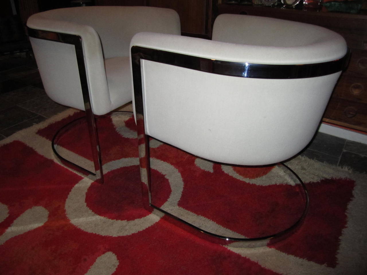 Stunning pair of Milo Baughman style chrome tub chairs. Solid chromed flat bars support sleek and sexy barrel back tub seats.