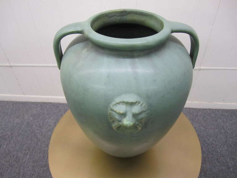 Outstanding rare form huge Burley Winter handled urn. Gorgeous mottled turquoise glaze with a wonderful lion's heads on both sides. I actually have a pair but one shows a repair to the handle so I am selling the one and if you want the other one I