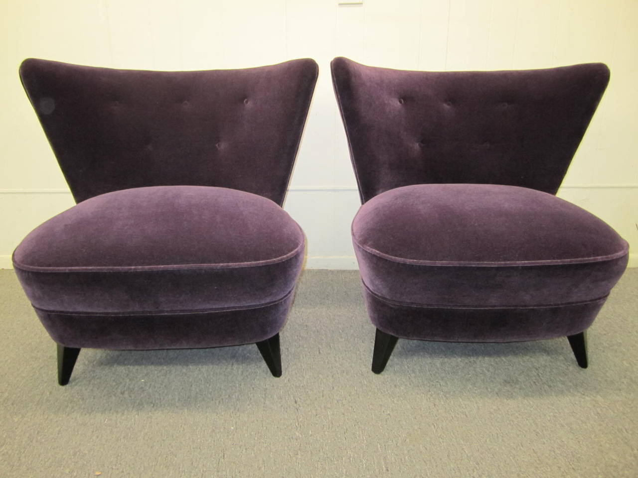 Stunning pair of Gilbert Rhode wing back slipper chairs.  These chairs have been totally restored with gorgeous high end vintage purple mohair,new foam, and freshly ebonized legs.  Super high style and extremely comfortable. The newly upholstered