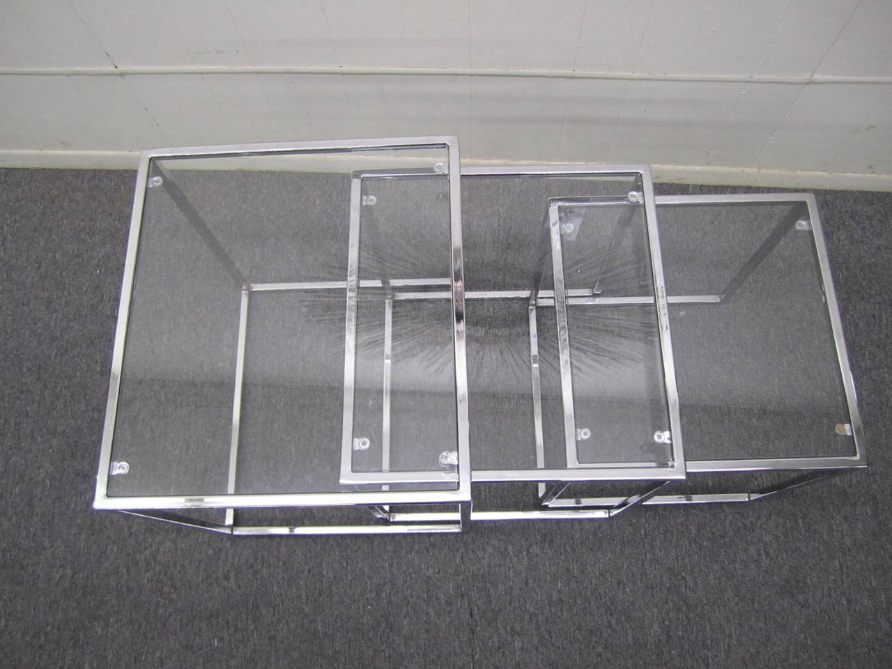 Fantastic set of Milo Baughman cube shaped chrome nesting tables.  This fine set is in excellent vintage condition.