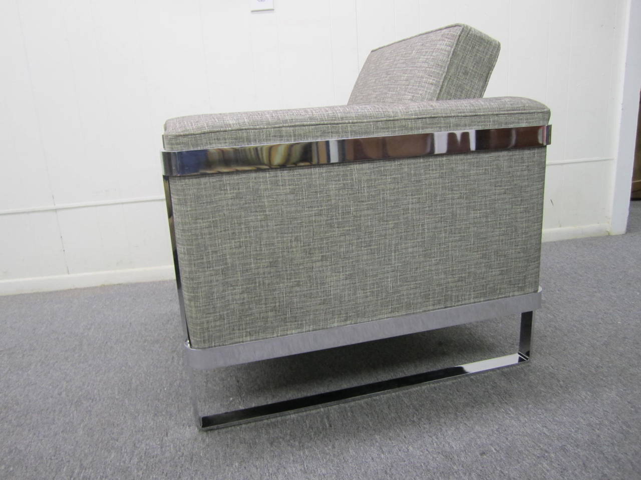 Excellent chrome flat bar lounge chair. This chair has been newly reupholstered within the last year with a handsome woven grey fabric-looks quite nice. The chrome flat bars are solid thick steel and weights a ton. 