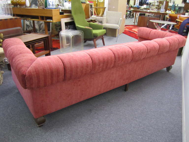 Stunning Harvey Probber style long low sleek sofa.  This unusual sofa features spectacular carved solid walnut feet.  The upholstery is a textured woven salmon color and still looks fantastic.  I love the thick padded arms and back rest giving it a